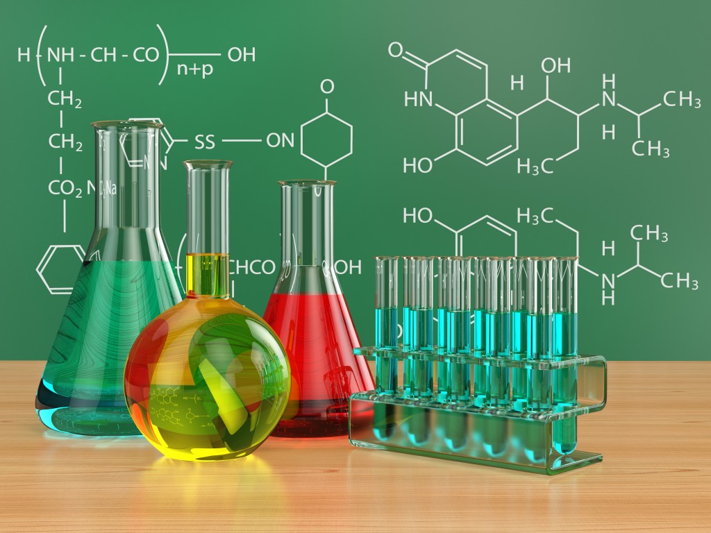 Chemical flasks and blackboard with formulas.